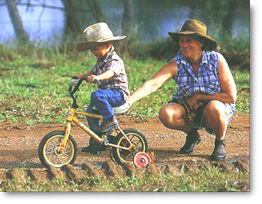 Sue Atkinson helps her grandson Callum with his bike.